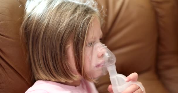 Child making inhalation of hormonal medicine through nebulizer 4k movie slow motion. Treatment of obstructive bronchitis in children concept  - Filmati, video