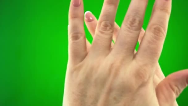 on green background chromakey female hands deny something closing picture sharply with both hands woman shows heart with hands with french manicure waving in different directions further shows figs - Felvétel, videó