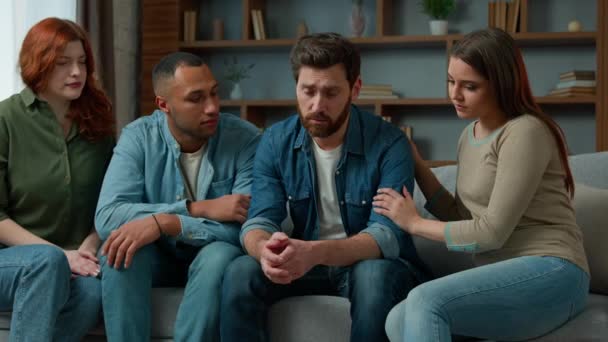 Sad desperate upset caucasian adult 30s man share life problem grief in group therapy session at home diverse people multiracial friends women men helping supporting give psychological help empathy - Video, Çekim