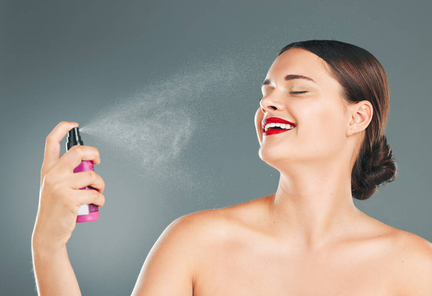 Perfume, woman and luxury beauty product of a model feeling happy about parfum smell and skincare. Spa, happiness and dermatology aesthetic of bottle water for facial and self care spray in studio. - Foto, Bild
