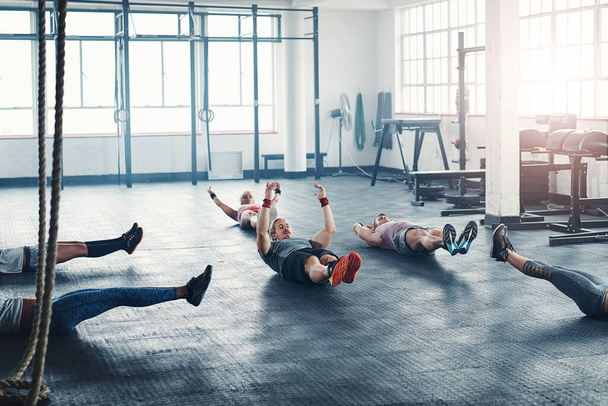 Every day is a chance to be better. an accountability group working out at the gym - Fotoğraf, Görsel