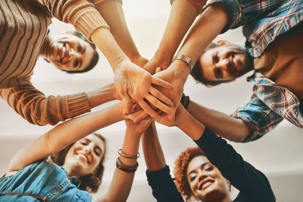 You can do anything but together we can do everything. creative employees huddled together touching hands in the office - Foto, imagen