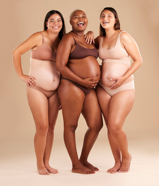 Pregnant body, portrait or laughing women on studio background in diversity empowerment, baby support and community. Smile, happy or pregnancy friends in underwear with stomach in funny or comic joke. - Foto, Bild