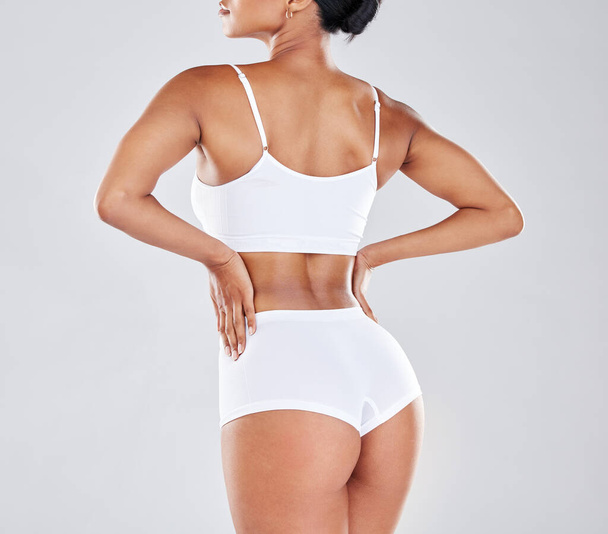 Body, wellness and back of woman after fitness exercise, workout and training to lose weight in studio. Motivation, self care and female model for cellulite treatment, diet and healthy lifestyle. - Photo, Image