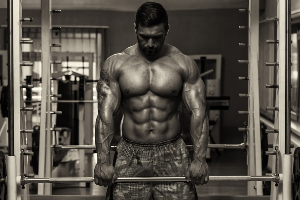 Bodybuilder Doing Trapezius Exercise - Фото, изображение
