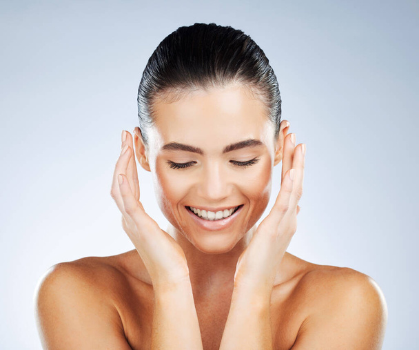 Happy, health and skincare of natural woman with smile for hydration, self care and glow aesthetic of people. Dermatology, beauty and healthy skin of person on isolated gray studio background. - Photo, Image