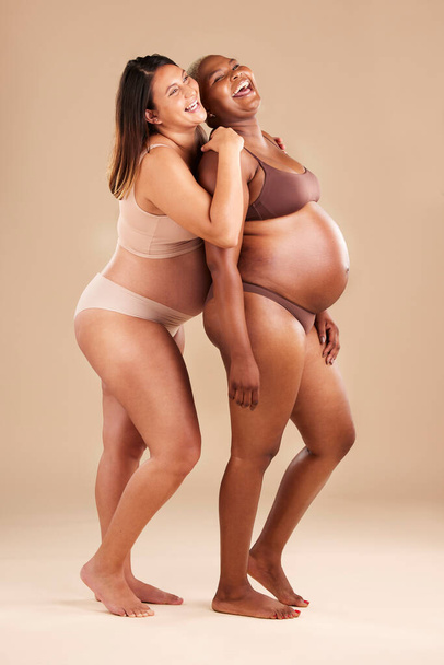Pregnant, beauty or laughing women on studio background in body empowerment, baby support or community mockup. Smile, happy or pregnancy friends in underwear in funny, bonding or family planning joke. - Foto, immagini