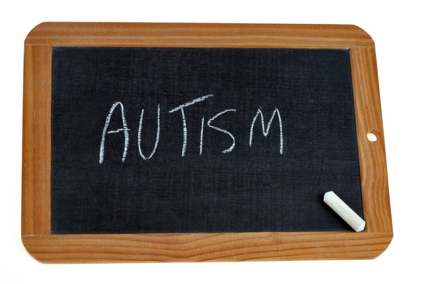 School slate on which is written autism with chalk - Foto, Imagen