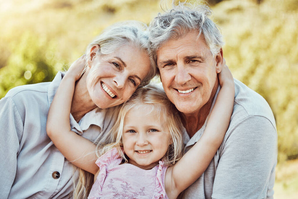 Grandparents, girl and smile portrait in a family outdoor park happy about a picnic. Children, happiness and kids with elderly grandparent in garden or backyard smiling and bonding together in nature. - Foto, Imagen