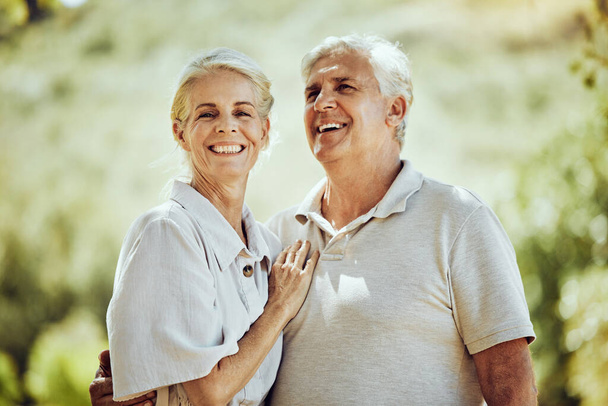 Love, senior couple and hug outdoor, retirement and quality time for bonding, adventure and romance. Romantic, mature woman and old man embrace, nature and loving together with smile and summer break. - Foto, immagini