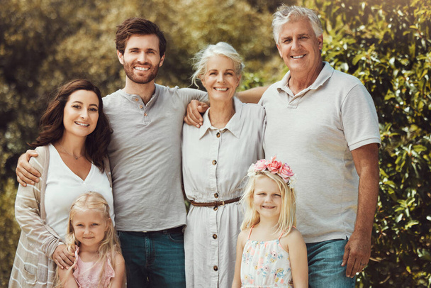 Nature, happy and portrait of a big family in a garden while on a summer vacation together. Parents, grandparents and children on holiday, adventure or weekend trip at an outdoor park with happiness - Foto, Imagem