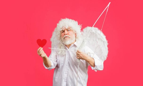 Valentines Day. Angel in white wings with bow and arrow hold red paper heart. Valentine cupid. Love - Foto, immagini