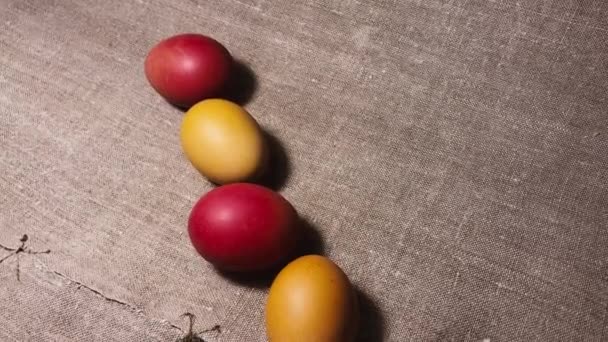 Painted easter eggs on a brown linen bedspread. Easter eggs. Red, brown and yellow chicken eggs. - Záběry, video