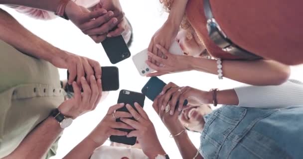 Hands, phone and networking with friends standing in a huddle or circle from below for communication. Social media, mobile and 5g with a man and woman friend group connected to the internet together. - Video, Çekim