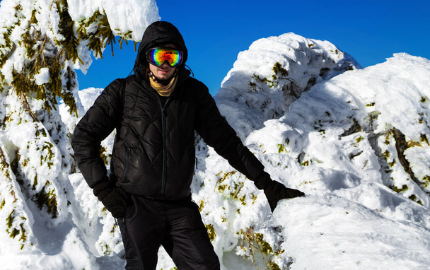Young man in the winter mountains. Winter sports. Mountain landscape. Skiing and mountain climbing. - Foto, immagini