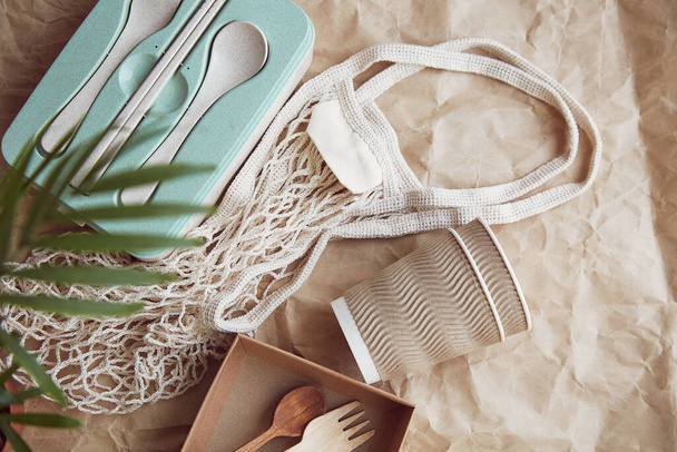 Natural, eco-friendly, plastic free, zero waste tableware. Eco shopping bag on crumpled paper. Sustainable lifestyle. - Photo, Image
