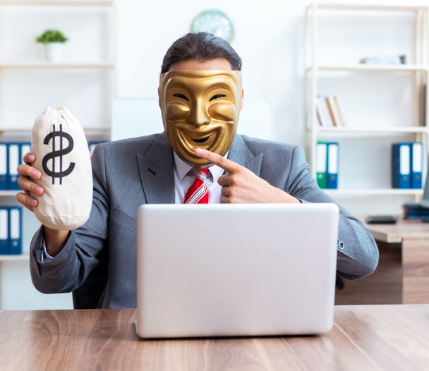 The businessman wearing mask in hypocrisy concept - Photo, Image