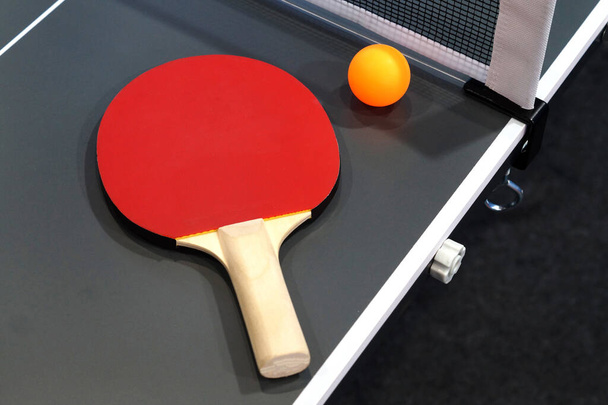 Close-up view of table tennis bat ball and net set                                  - Photo, image