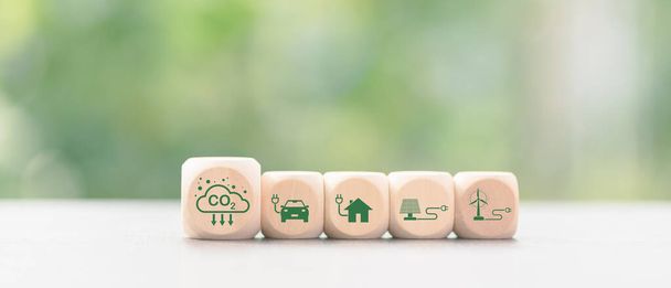 Industrial emissions pollute the environment and ecosystems. including climate change Carbon Renewable Energy Agreement reduce greenhouse gas emissions ,icon and wooden blocks on table - Foto, Imagem