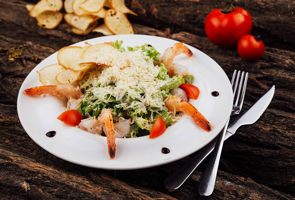 Caesar salad shrimps on white plate - Photo, image