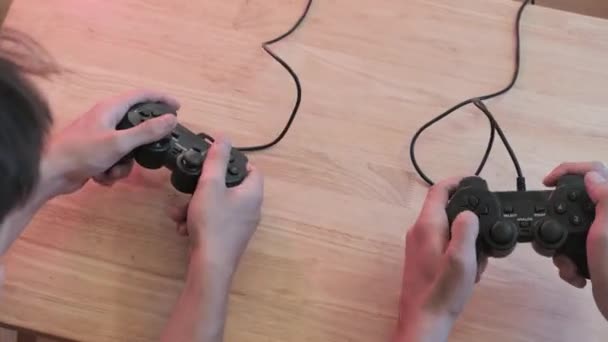 Top view of two guys with controllers playing exciting video game indoors - Metraje, vídeo