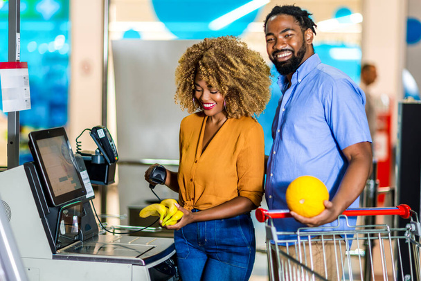 African American Ζευγάρι αγοράζουν τρόφιμα στο μπακάλικο ή σούπερ μάρκετ self-checkout - Φωτογραφία, εικόνα