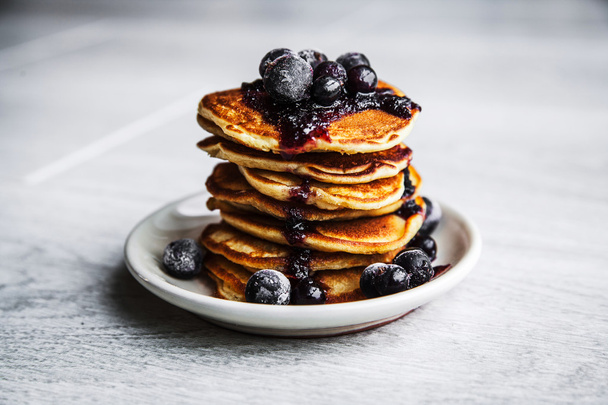 Picture of few pancakes with blackberries and sugar on wooden background - Foto, imagen