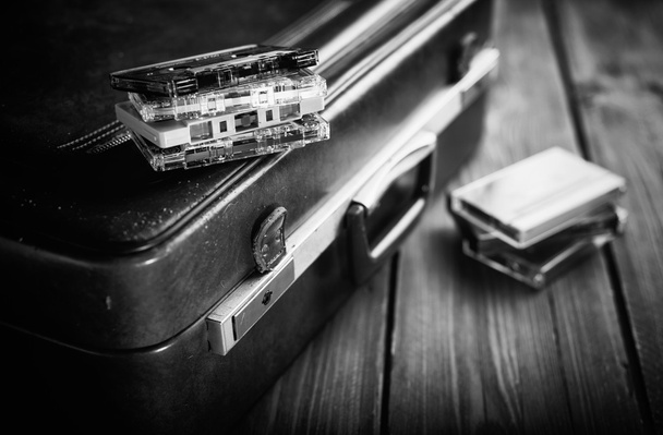 Cassette tape lying on an old suitcase. Vintage Retouching - Photo, Image