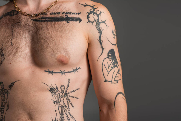 Cropped view of shirtless and tattooed man standing isolated on grey  - Fotografie, Obrázek