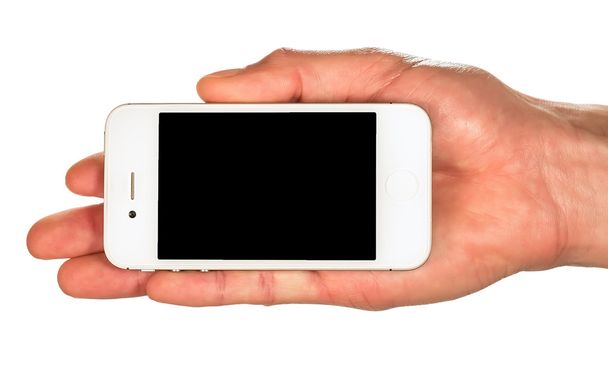 Main tenant un smartphone blanc avec écran noir isolé sur wh
 - Photo, image