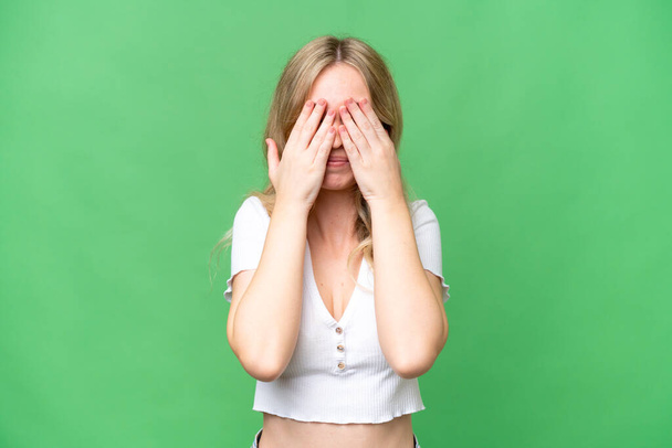Young English woman over isolated background covering eyes by hands - 写真・画像