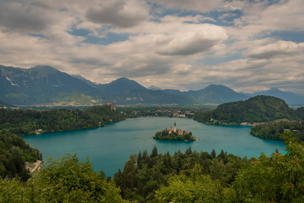 Island on lake in Bled town in Slovenia in cloudy summer rainy day - 写真・画像