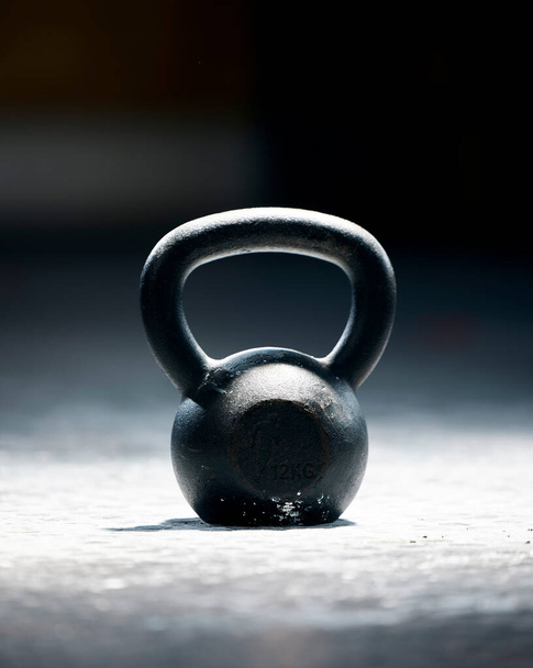 Fitness, motivation or kettlebell at a gym with mockup space for strength training, exercise or workout. Zoom, metal equipment or heavy weight for strong muscle development or growth in health club. - Photo, image