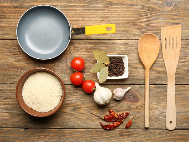 Food ingredients and kitchen utensils for cooking on wooden background - Foto, Imagem