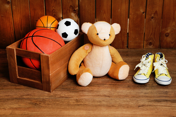 Bear toy with toys on wooden background - Zdjęcie, obraz