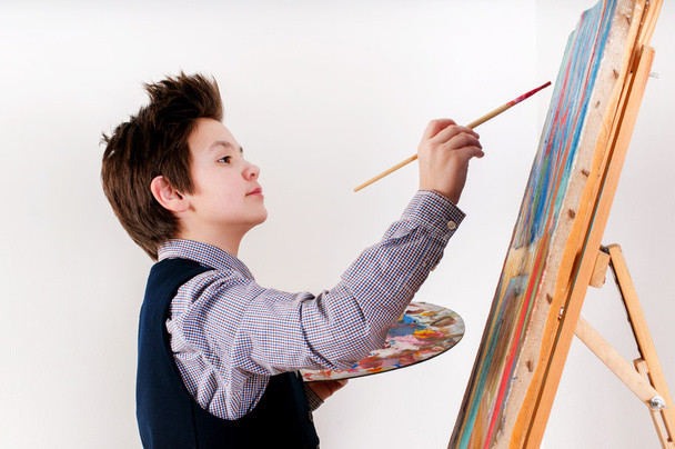 Artist school boy painting brush watercolors portrait on a easel - Foto, Bild