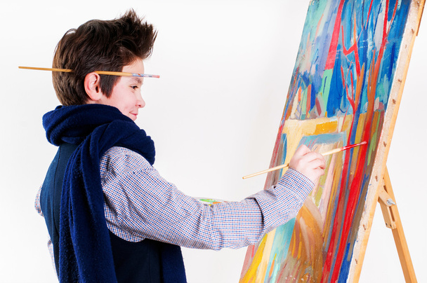 Artist school boy painting brush watercolors portrait on a easel - Photo, Image