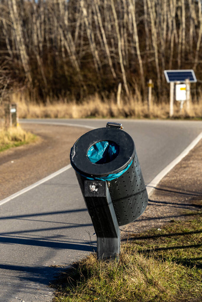 Copenhagen, Denmark A tilted and angled garbage can on a bike path so that bicyclist can toss garbage while bicycling. - Фото, изображение