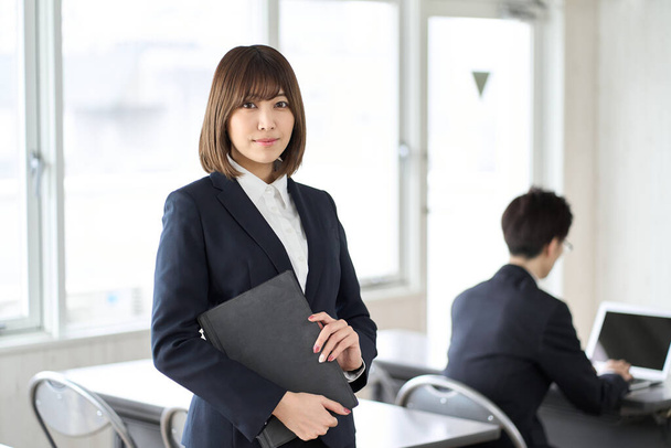 Asian businesswoman with tablet in seminar room - Photo, image