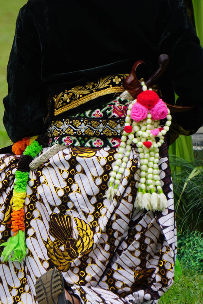 Keris on the back of Javanese. Keris is one of the Indonesian traditional weapons. People who make keris are called empu - Fotó, kép