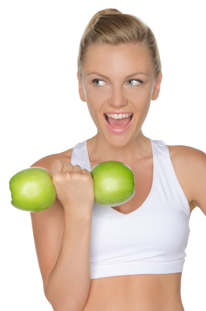 Mujer con mancuernas de manzanas verdes mirando hacia otro lado
 - Foto, imagen