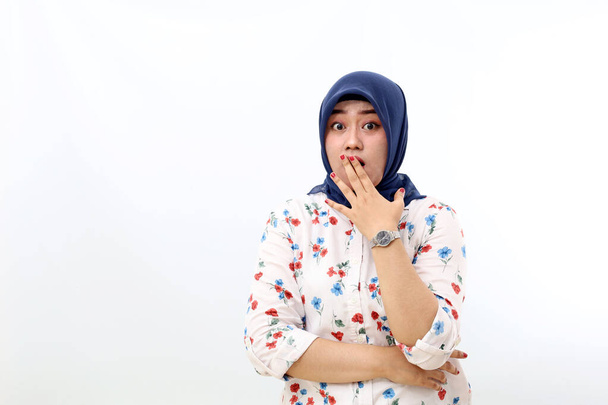 Shocked asian muslim woman standing while covering her mouth. Isolated on white background - Foto, Imagen