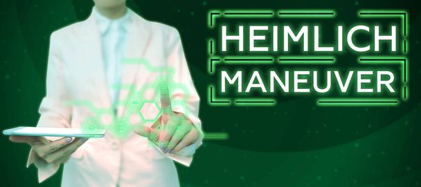Hand writing sign Heimlich Maneuver, Business showcase application of upward pressure in case of choking - Fotoğraf, Görsel