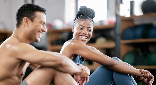 Fitness, relax or personal trainer with a happy client at gym for training, exercise or body workout. Team partnership, funny coach or tired black woman resting, laughing or bonding on break together. - Фото, изображение