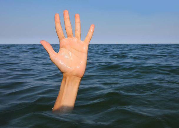 Open hand with five fingers of the person who is drowning in the sea - Photo, Image