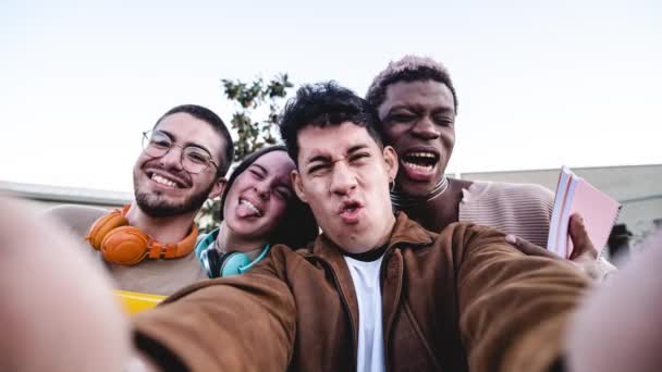 Stop motion group of cheerful multiracial students making faces and taking selfie after university studies - Záběry, video