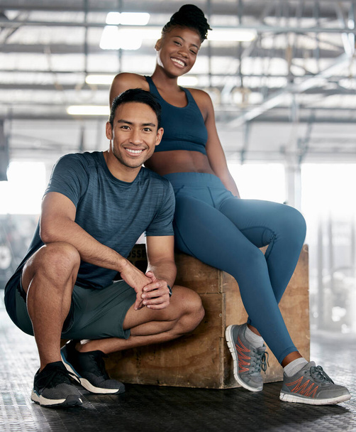 Fitness, portrait or personal trainer with a happy client at gym for training, exercise or body workout. Team partnership, Indian coach or black woman smiles with pride together in a health club. - Foto, Imagen