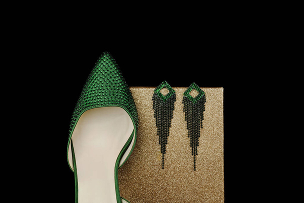 Beautiful green woman shoes with brilliant isolated  background - 写真・画像