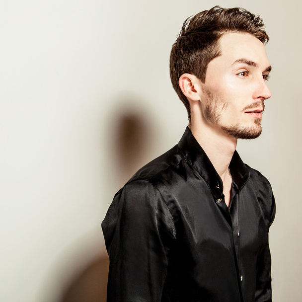 Elegant young handsome man in black silk shirt. Studio fashion portrait. - Photo, Image
