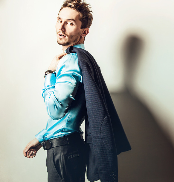 Elegant young handsome man in blue silk shirt. Studio fashion portrait. - Fotoğraf, Görsel